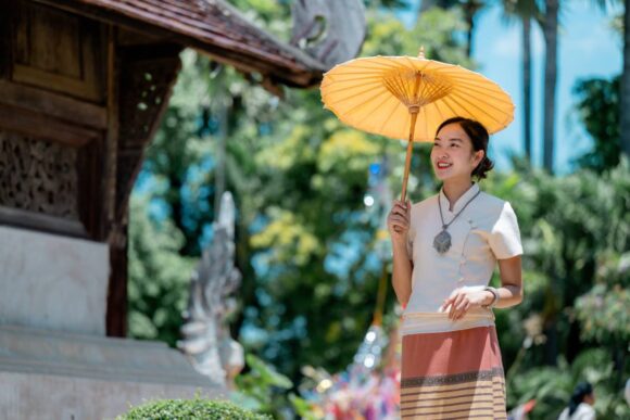 beautiful-thai-woman-holding-traditional-umbrella-2025-10-26-16-19-25-utc (1) ปีใหม่ 2568 เที่ยวไหนดี? รวม 10 จุดเช็กอินยอดนิยมต้อนรับปีใหม่