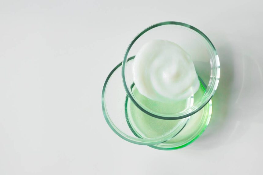 Glass petri dishes with various cosmetic products on white background, copy space. Shampoo, hair conditioner or mask and shower gel, above